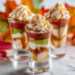 Twisted Candy Apple Shots with caramel drizzle and whipped cream