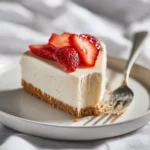 Philadelphia no bake cheesecake slice on white plate with strawberry topping and graham cracker crust