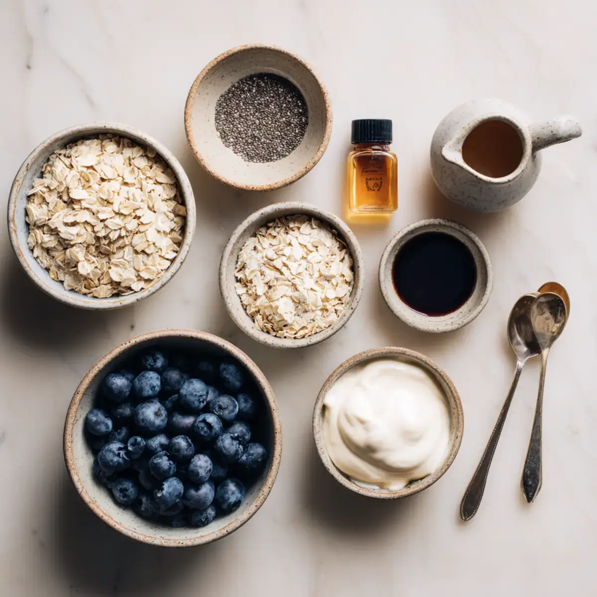 Ingredients for overnight oats with yogurt including rolled oats, Greek yogurt, chia seeds, and blueberries
